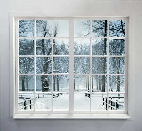 A winter window replacement with a view of a snowy landscape.
