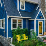 A blue house with a yellow door.