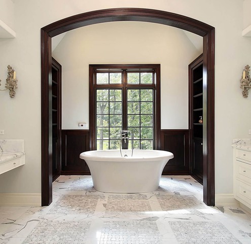 A bathroom with a large tub and a large window.