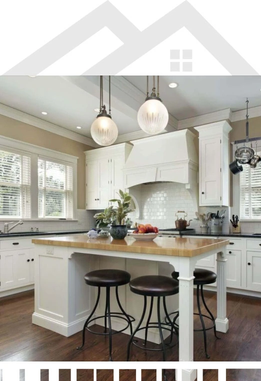 A photo of a kitchen with white cabinets and a center island.