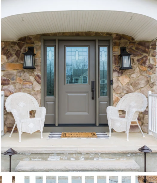 A front porch with white chairs and a stone front door.