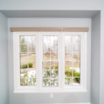 A window in a room with white trim.