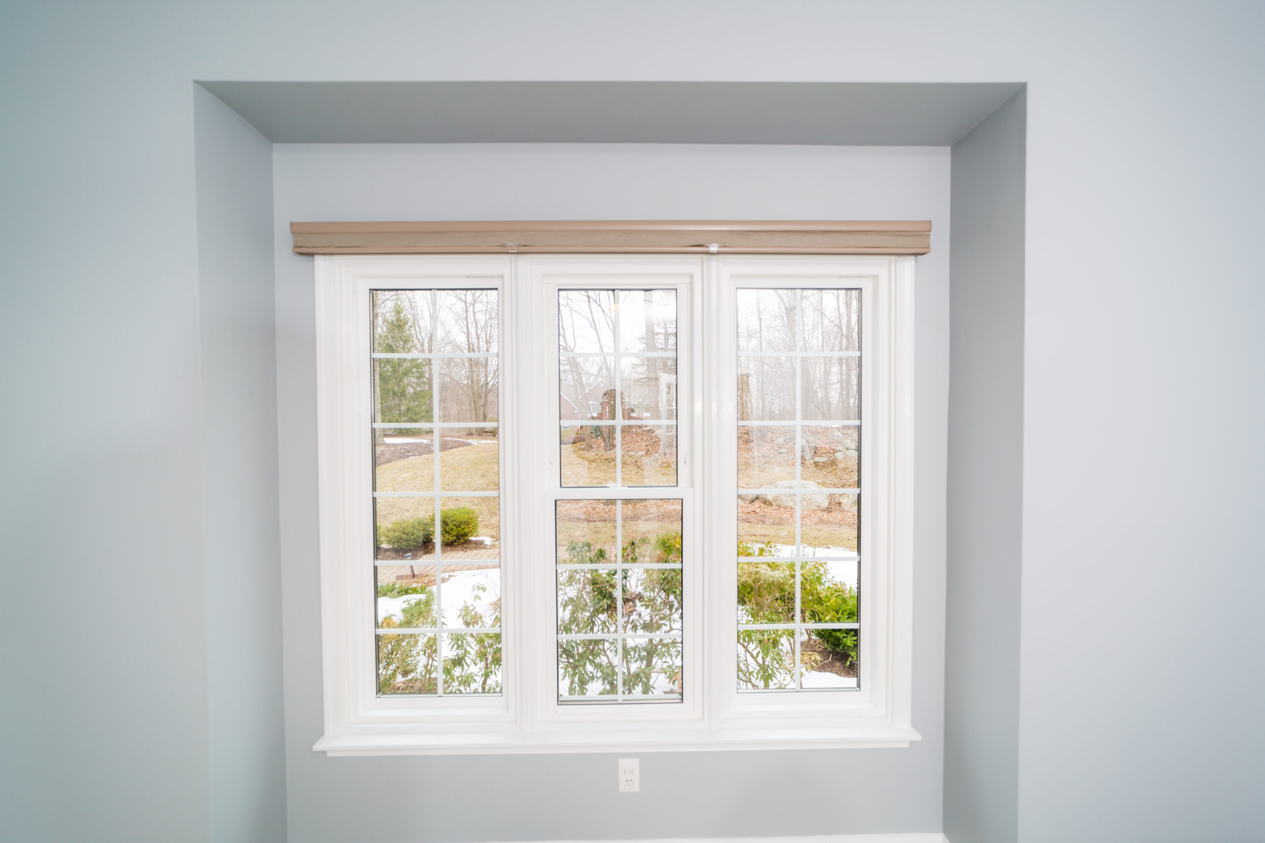 A window in a room with white trim.