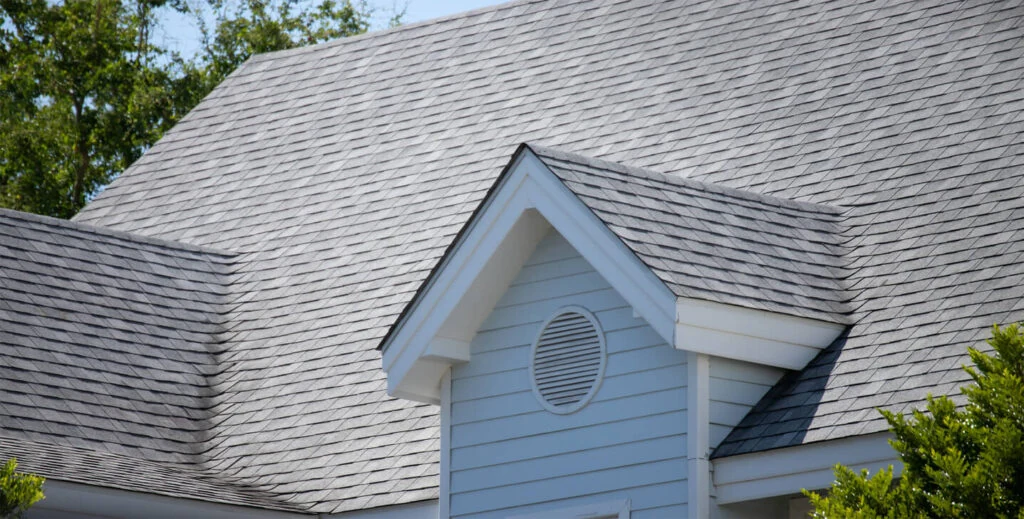 A detailed view of architectural shingle roofing, illustrating a popular choice in roofing material selection for its aesthetic and practical benefits in home renovations.